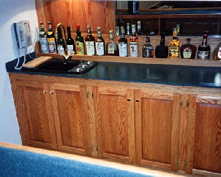 Oak cabinets behind bar